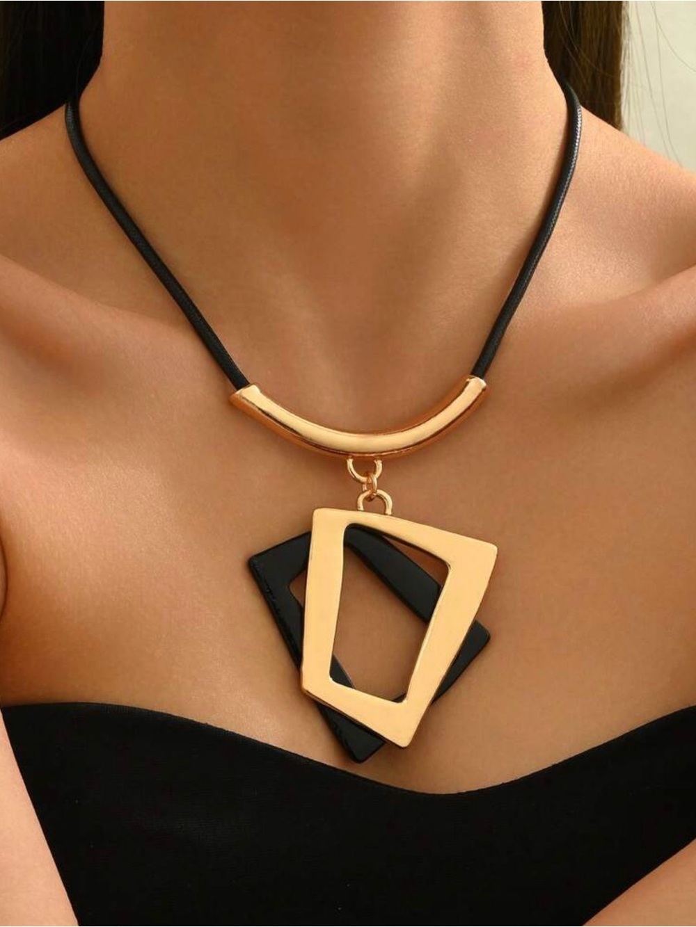 : Geometric Layered Pendant Necklace with Black Cord and Gold-Tone Hardware.